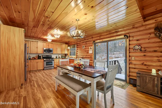 a dining room with furniture and wooden floor