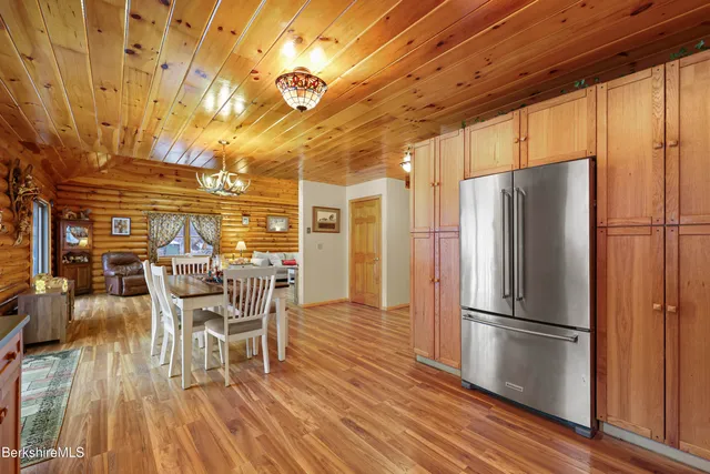 a kitchen with stainless steel appliances a refrigerator and wooden floor