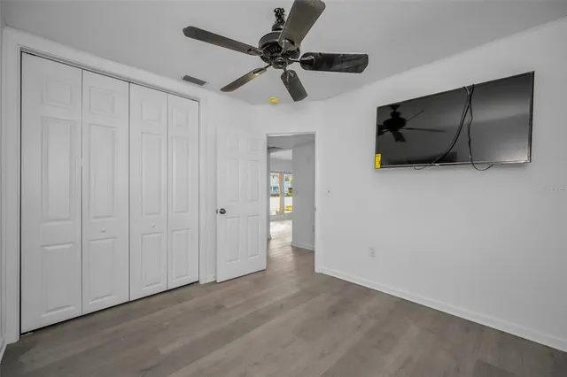 a view of an empty room with a ceiling fan