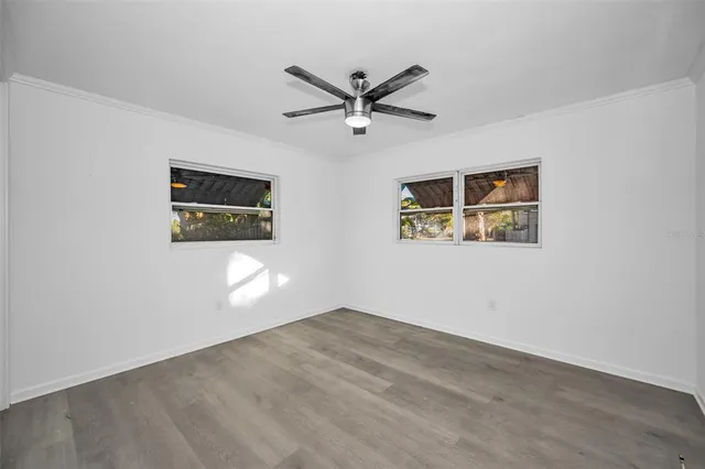 a view of a ceiling fan with wooden floor