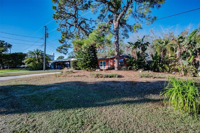 a swimming pool with outdoor seating and yard