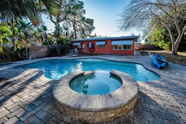 a view of a house with swimming pool and sitting area
