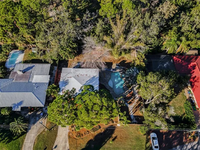 an aerial view of a house with a yard and plants