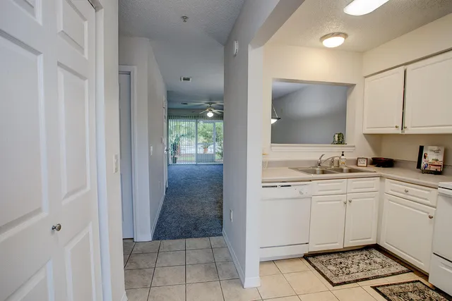 a kitchen with cabinets appliances a sink and a counter top