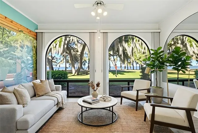 a living room with fireplace furniture and a large window