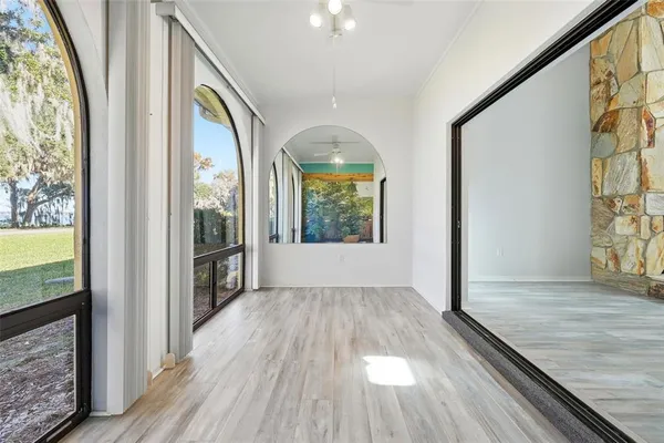 workspace with wooden floor mirror and windows