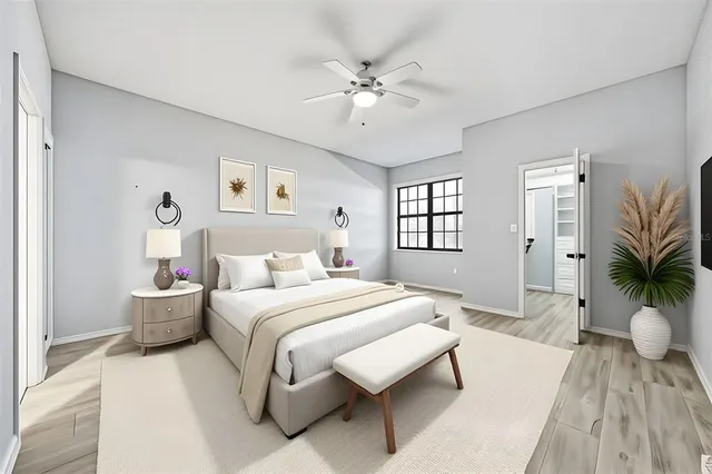 a bedroom with a large bed and a chandelier