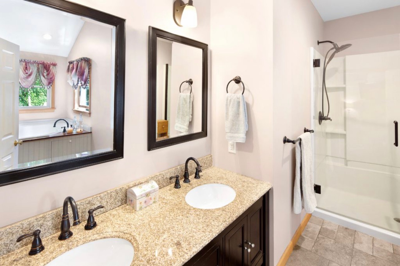 18 Cormorant Circle Edgartown, MA 02539 - Photo 12 of 42 a bathroom with a granite countertop sink and a mirror