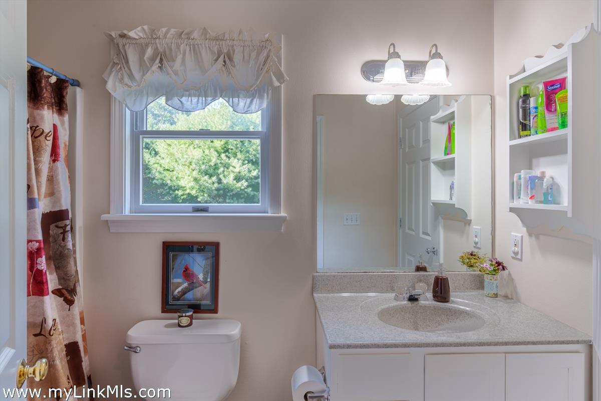 18 Cormorant Circle Edgartown, MA 02539 - Photo 18 of 42 a bathroom with a sink a large mirror and a window