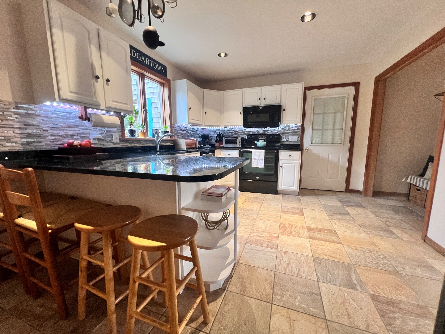 18 Cormorant Circle Edgartown, MA 02539 - Photo 8 of 42 a kitchen with stainless steel appliances kitchen island granite countertop a sink and cabinets