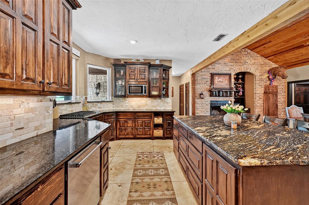 1717 1/2 Batey Road Collinsville, TX 76233 - Photo 14 of 40 a kitchen with stainless steel appliances granite countertop a sink and cabinets