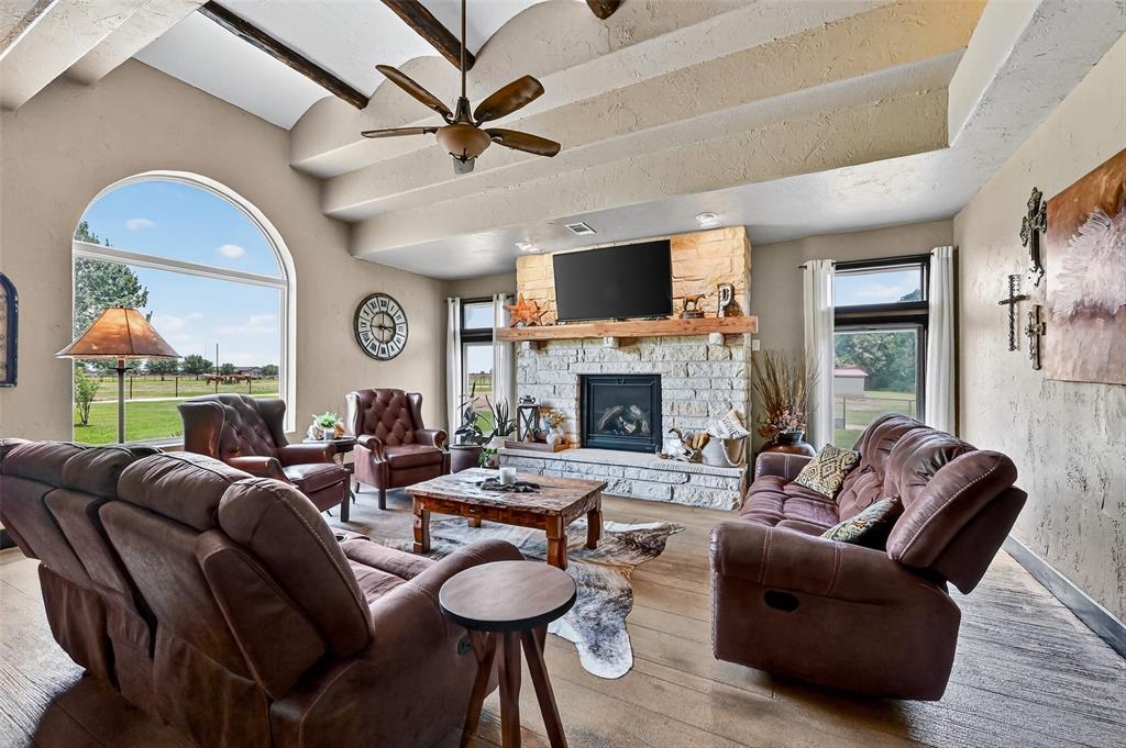 1717 1/2 Batey Road Collinsville, TX 76233 - Photo 15 of 40 a living room with furniture a fireplace and a flat screen tv