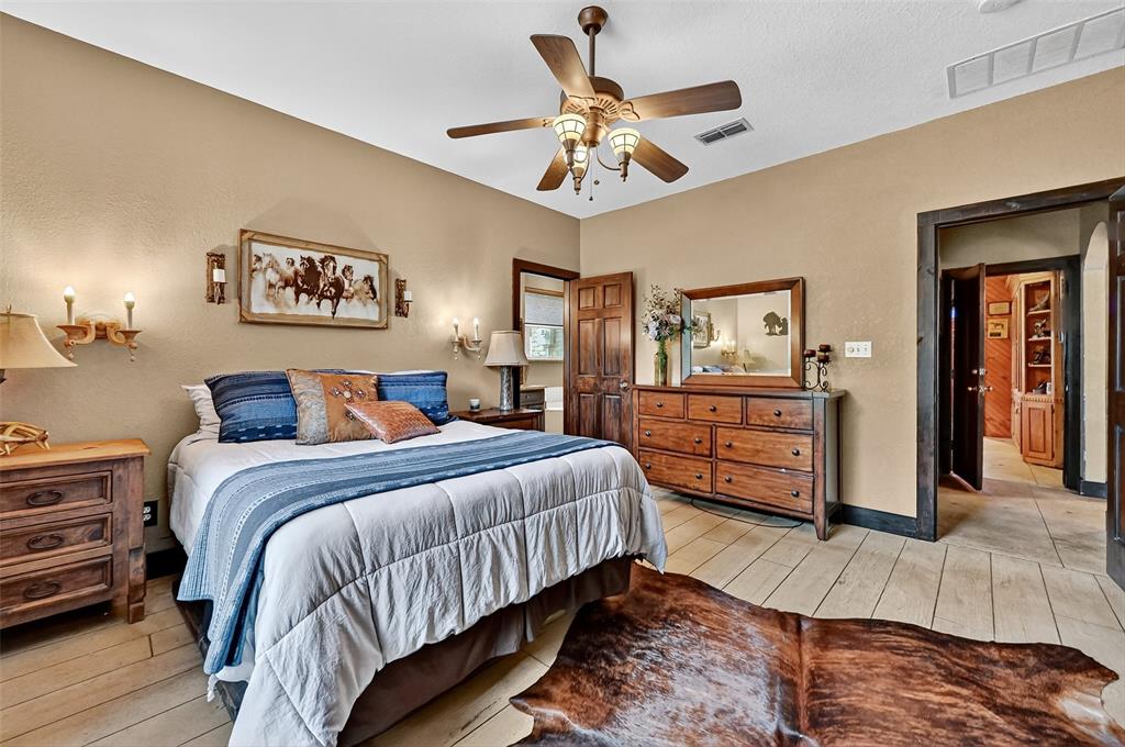 1717 1/2 Batey Road Collinsville, TX 76233 - Photo 24 of 40 a bedroom with bed and wooden floor