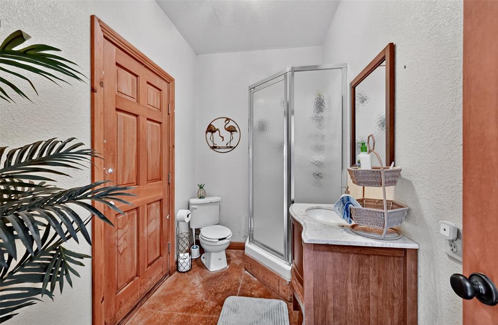 1717 1/2 Batey Road Collinsville, TX 76233 - Photo 29 of 40 a bathroom with a sink a toilet and a mirror