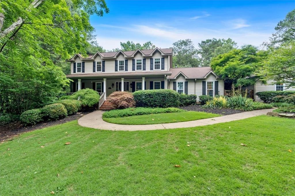 3656 Ebenezer Road Northeast Marietta, GA 30066 - Photo 1 of 1 a view of house in front of a big yard with large trees