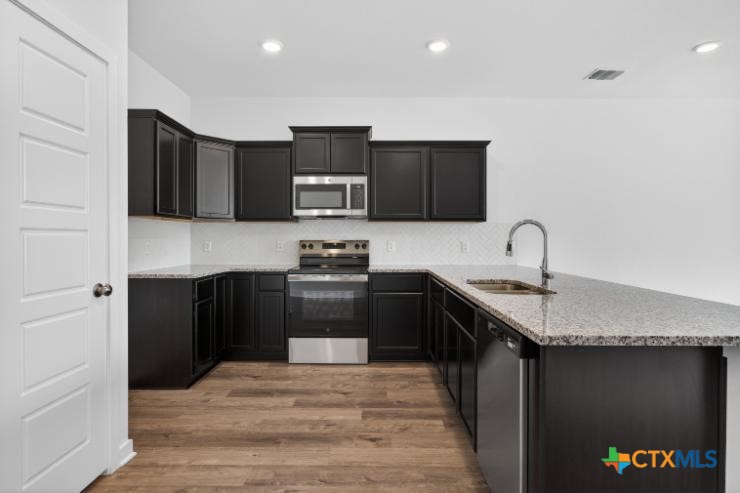 1915 Meridian Loop Temple, TX 76504 - Photo 11 of 29 a kitchen with stainless steel appliances granite countertop a refrigerator and a stove top oven