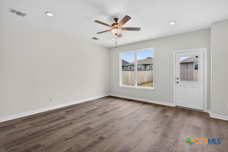 1915 Meridian Loop Temple, TX 76504 - Photo 14 of 29 an empty room with wooden floor and ceiling fan