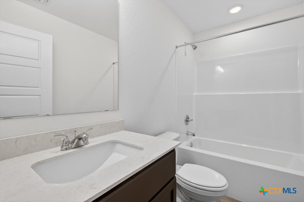 1915 Meridian Loop Temple, TX 76504 - Photo 17 of 29 a bathroom with a granite countertop sink toilet and shower