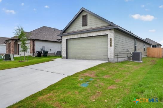 1915 Meridian Loop Temple, TX 76504 - Photo 4 of 29 a front view of a house with a yard and garage