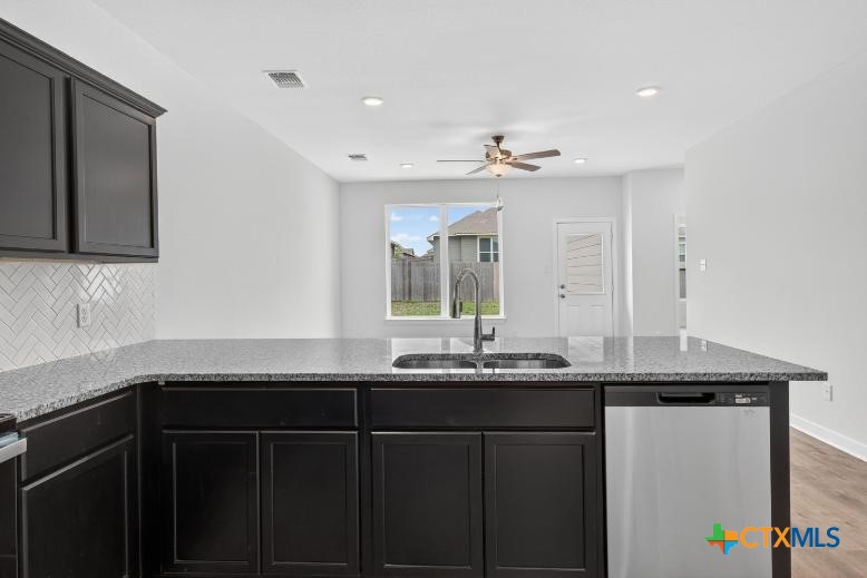 1915 Meridian Loop Temple, TX 76504 - Photo 6 of 29 a kitchen with granite countertop kitchen island white cabinets and sink