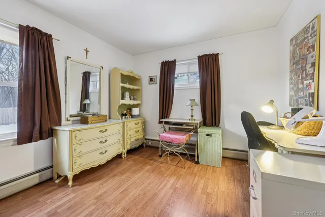 a view of a workspace with furniture and wooden floor