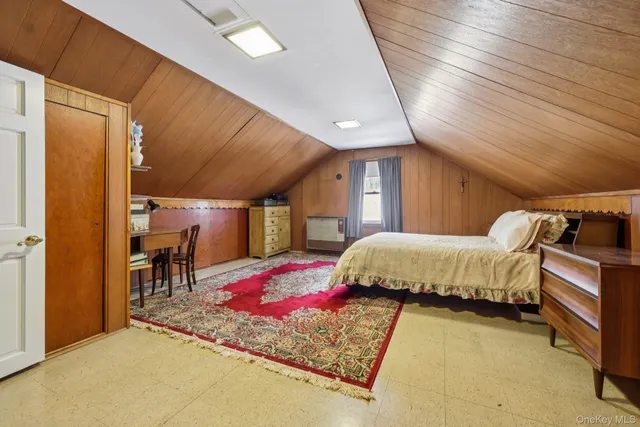 a bedroom with a bed and a table in it