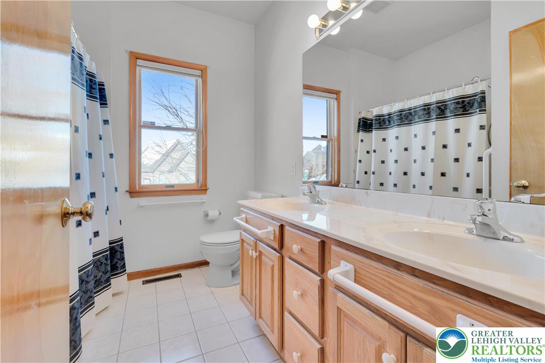 239 North 36th Street Allentown, PA 18104 - Photo 16 of 38 a spacious bathroom with double vanity and a mirror