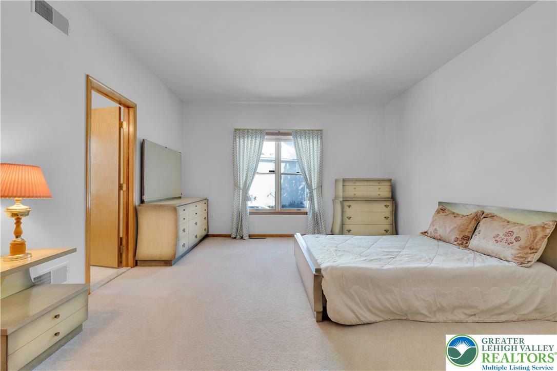 239 North 36th Street Allentown, PA 18104 - Photo 22 of 38 a spacious bedroom with a bed and a window