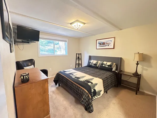 a bedroom with a bed and a flat screen tv