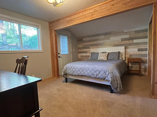 a bedroom with a bed and a table