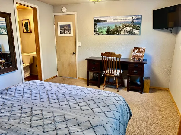 a bedroom with a bed and a lamp on table