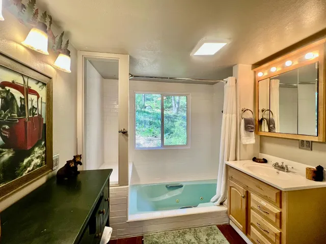 a bathroom with a sink mirror and a bathtub