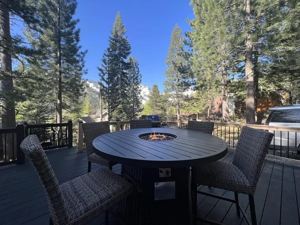 a view of a patio with a table and chairs