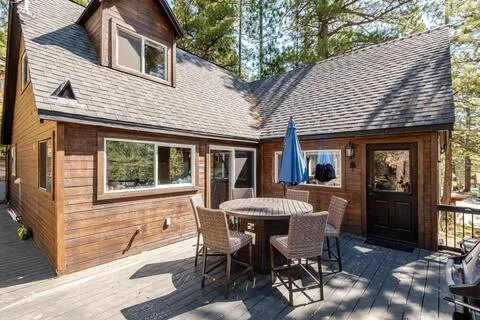 a view of a house with a chairs and table in a patio
