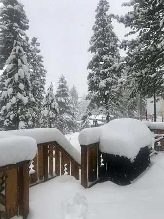 a roof deck with table and chairs under an umbrella