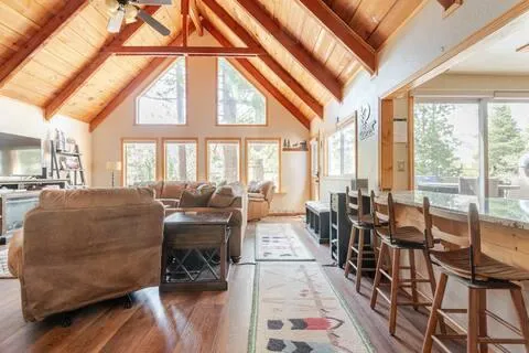 a living room with furniture and floor to ceiling windows