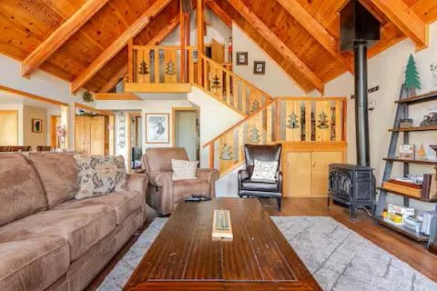 a view of living room kitchen with furniture and wooden floor