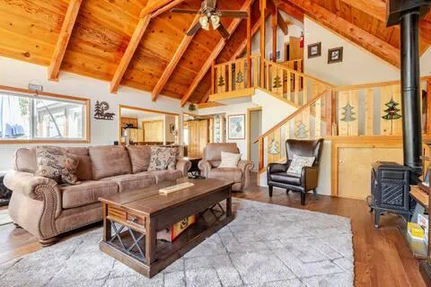 a living room with furniture a fireplace and large windows