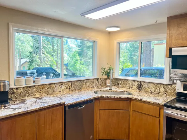 a kitchen with granite countertop a sink and a window