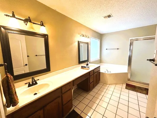 a bathroom with a tub sink and mirror