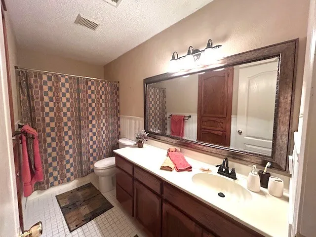 a bathroom with double vanity and a mirror