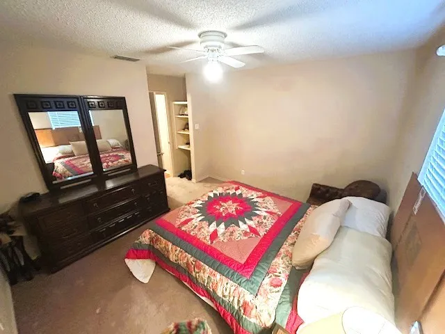 a living room with a bed furniture and a flat screen tv