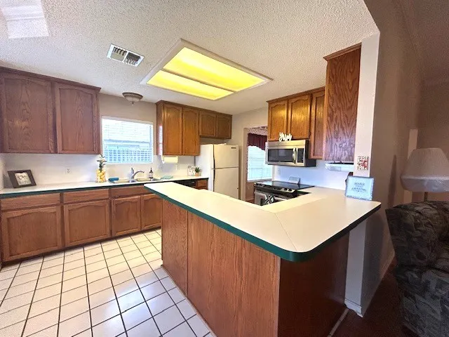 a kitchen with a sink cabinets and window