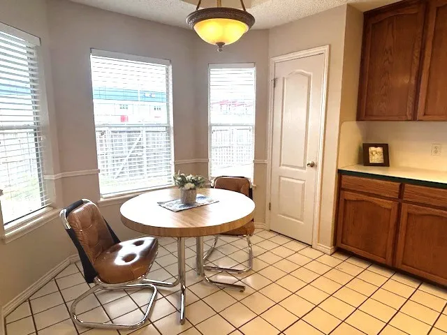 a view of a dining room with furniture and window