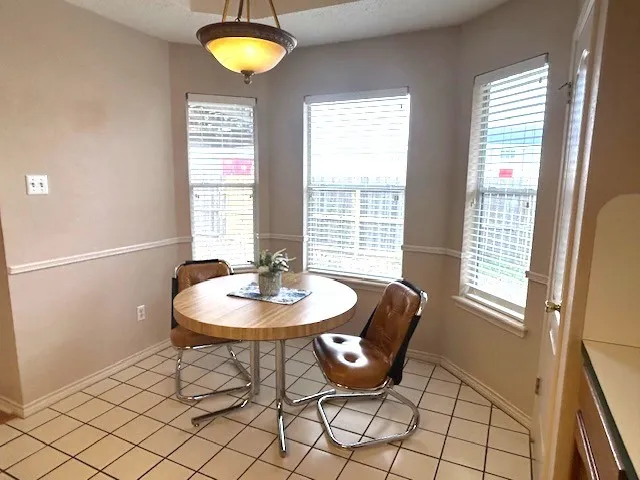 a view of a dining room with furniture and window