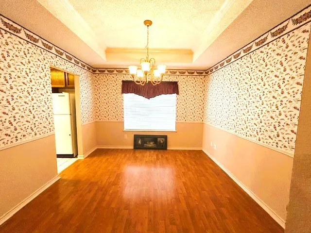 a view of a room with wooden floor a ceiling fan and window