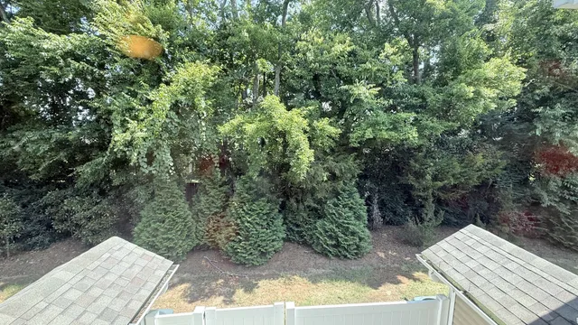 an empty room with a window and a ceiling fan