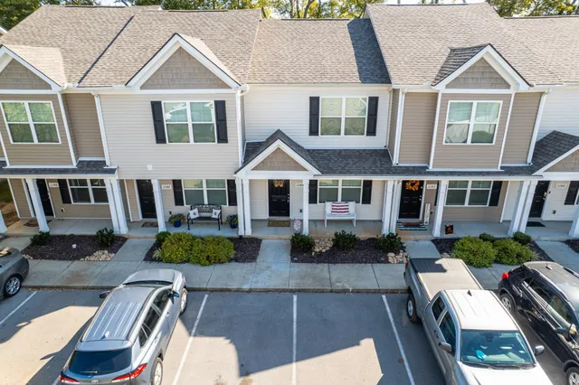 a kitchen with granite countertop a refrigerator and a stove top oven