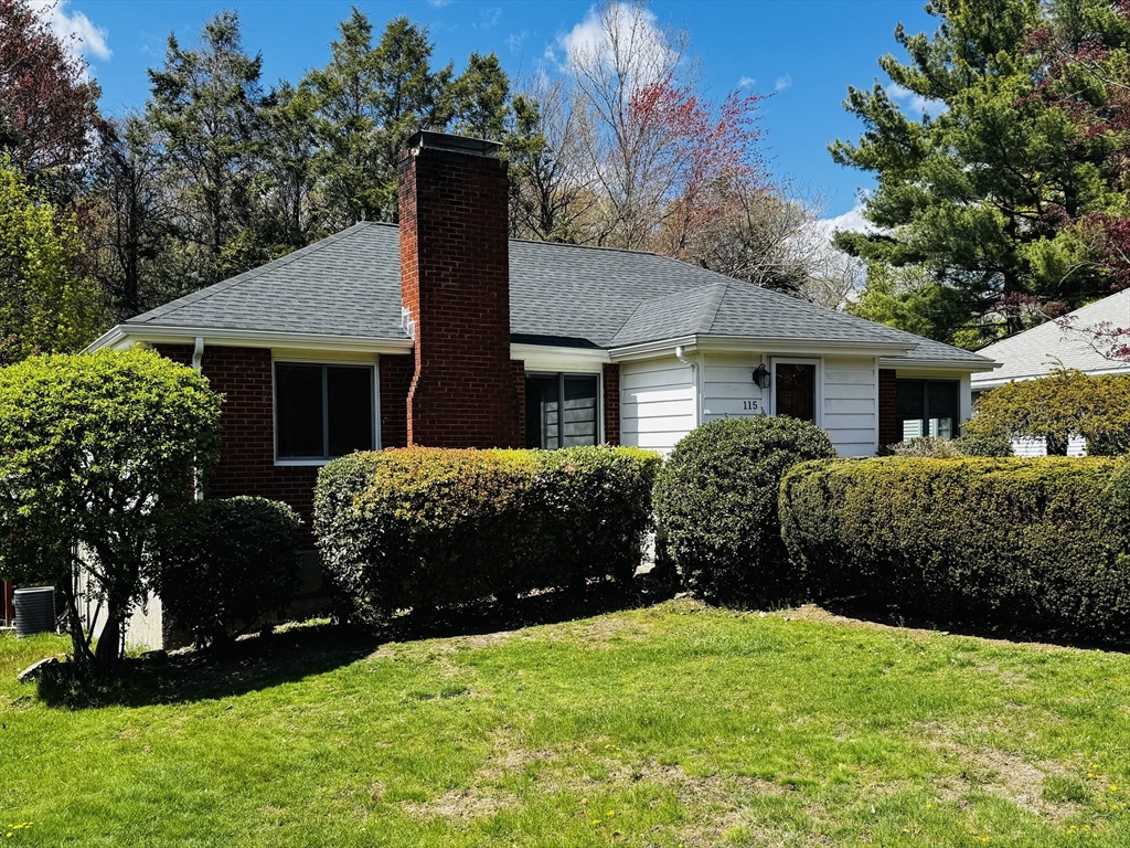 115 Grove Street Brookline, MA 02467 - Photo 1 of 12 a front view of a house with a garden