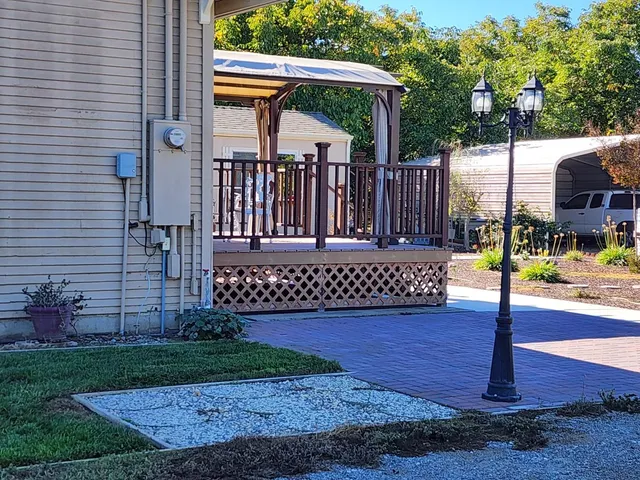 a view of a deck with a table and chair swing